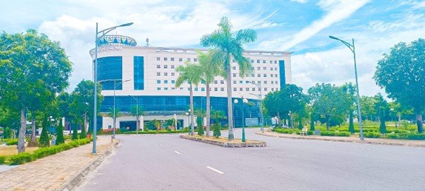 A building with palm trees and a street

Description automatically generated